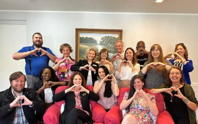 Staff of Christian Healing Ministries making their hands into a heart shape.