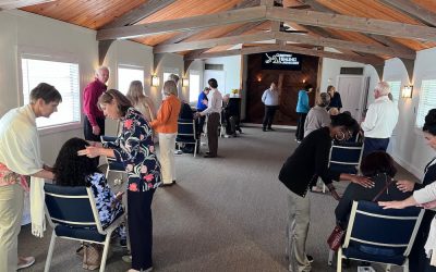 Prayer ministers praying over school students.
